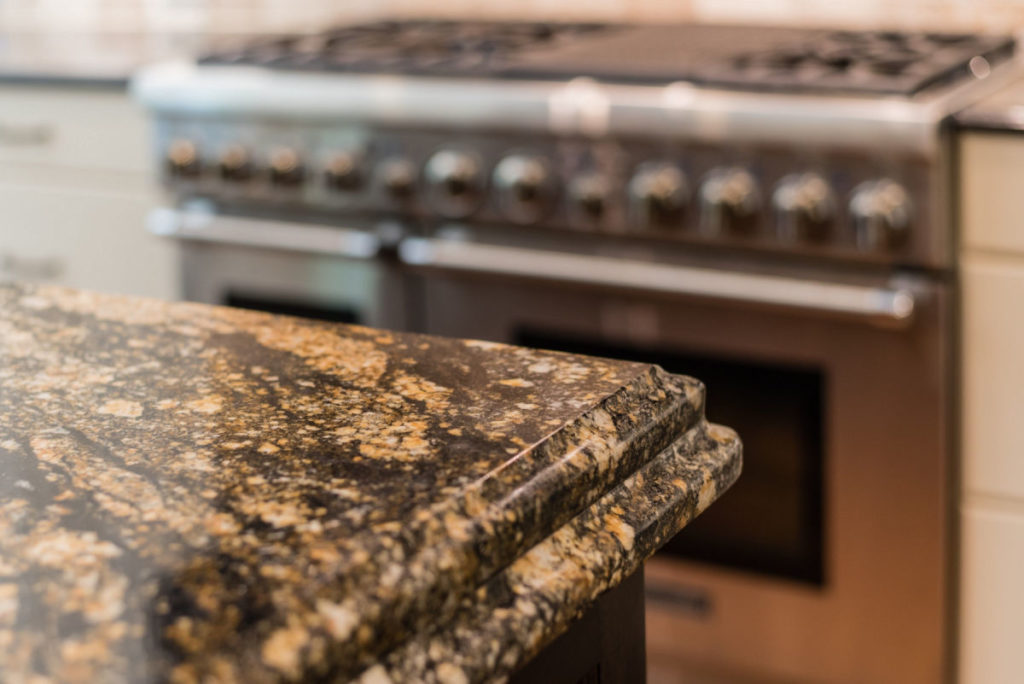 Brown and tan speckled granite countertop installed in the kitchen