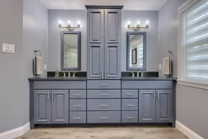 Double vanity with pale blue cabinets and floating mirrors