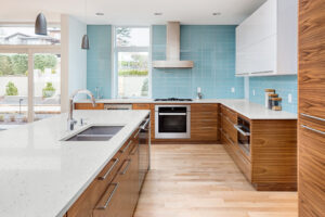 A modern kitchen featuring various kitchen countertop options Hershey PA including white quartz and natural wood